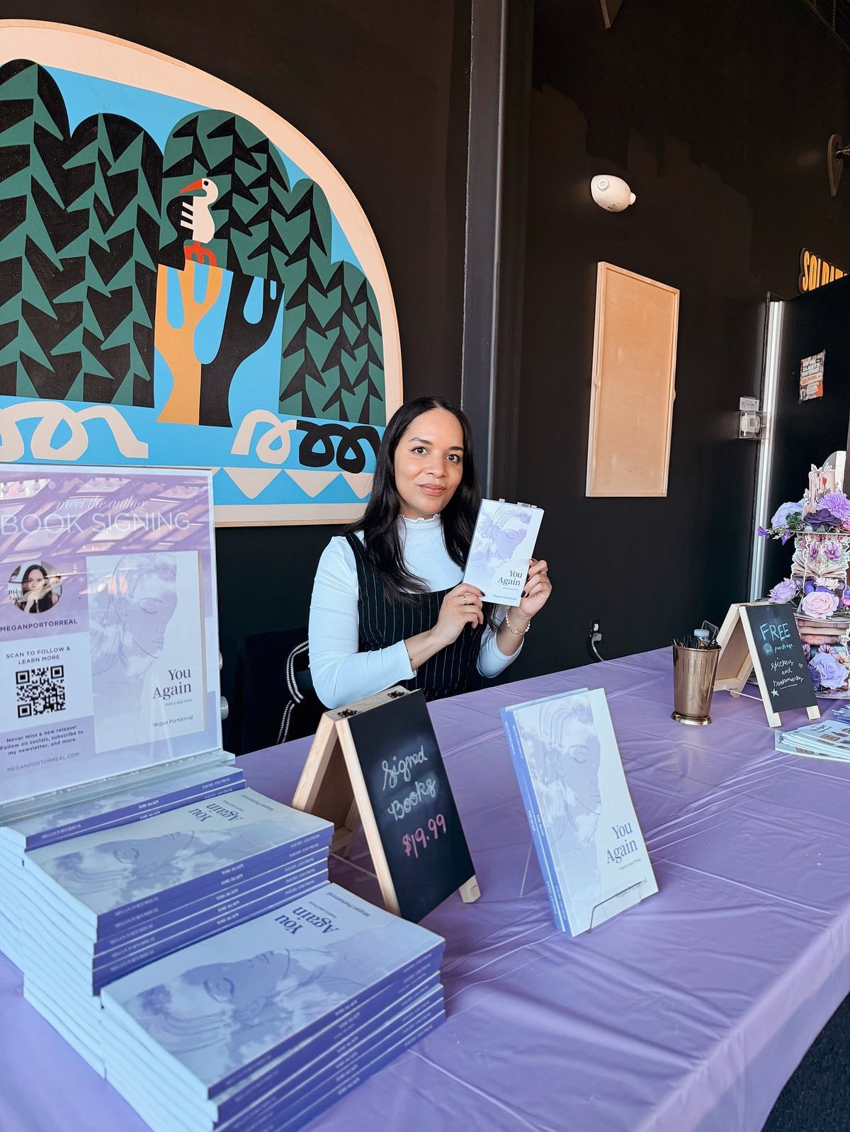 Author holding signed copy of You Again