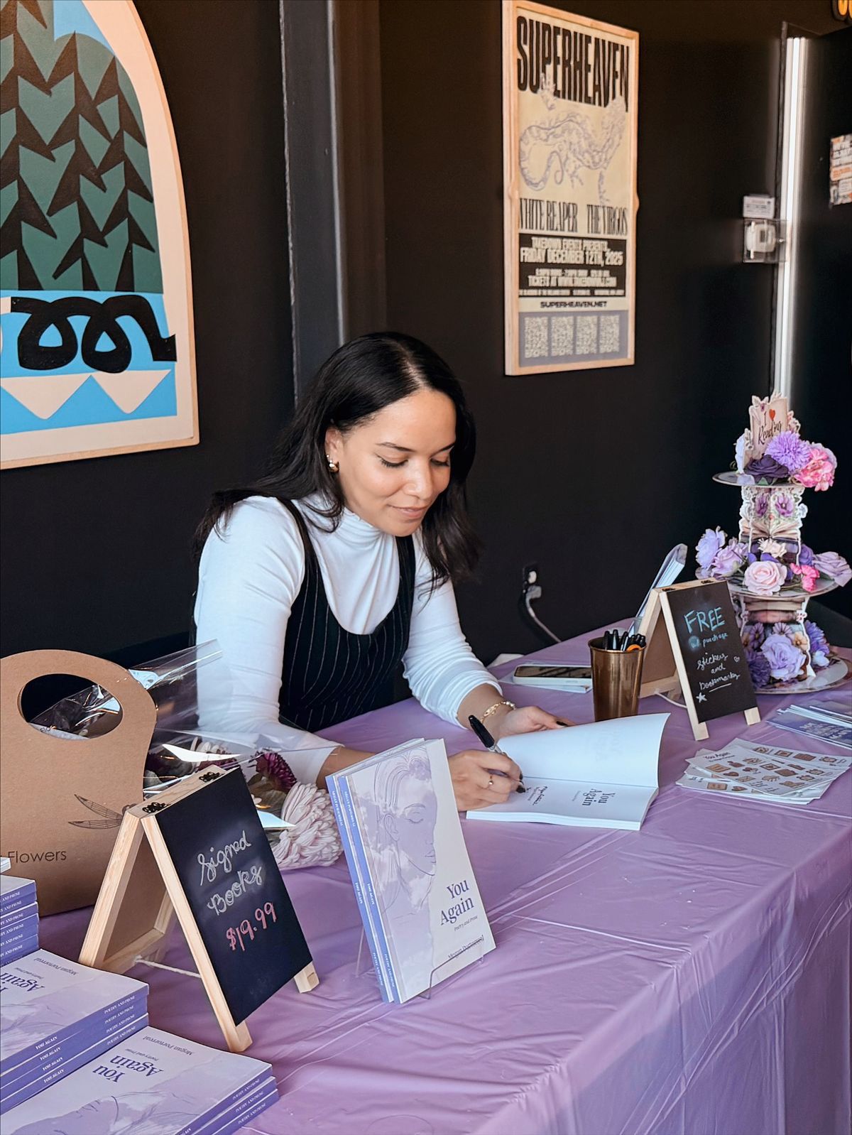 Author signing books at event